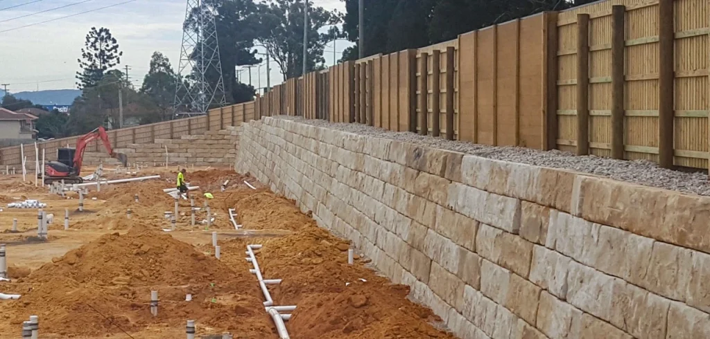 Explore how a Sandstone Retaining Wall can enhance your landscape Landscape with sandstone blocks